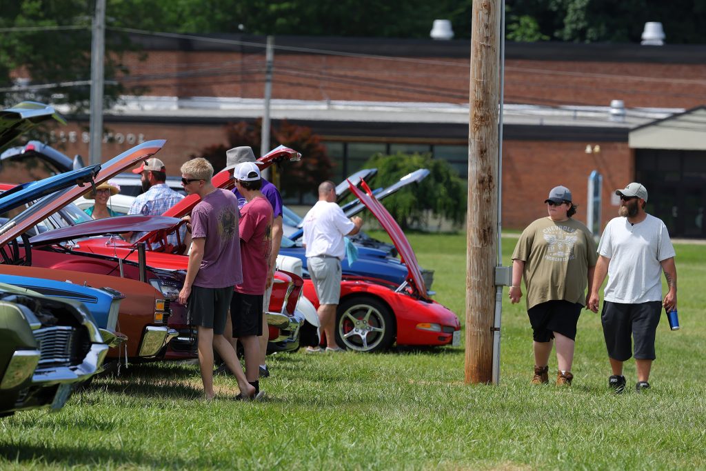 Attendees browsing cars at the show