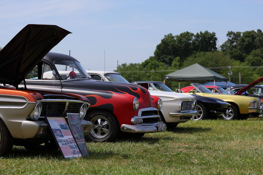 Classic muscle car with hood up at the show